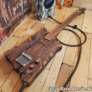 Guitare cigar box électrique solid body réalisée avec du bois de palette. Micro simple bobinage et look brun vintage. Guitare cigar box électrique solid body réalisée avec du bois de palette. Micro simple bobinage et look brun vintage.